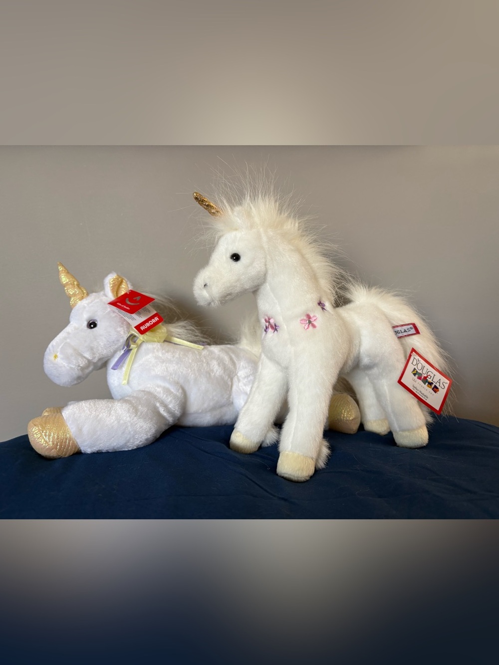 Aurora and Douglas White Unicorn Plushies with Gold Horn and Pink Flower Details